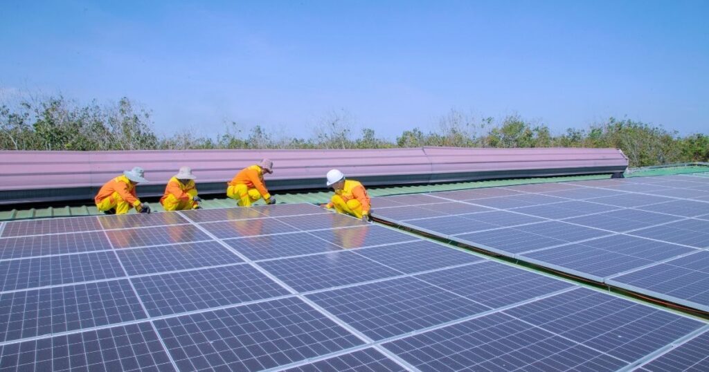 Team installing solar panels on commercial rooftop