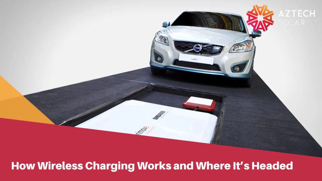 Silver car positioned over a wireless EV charging pad