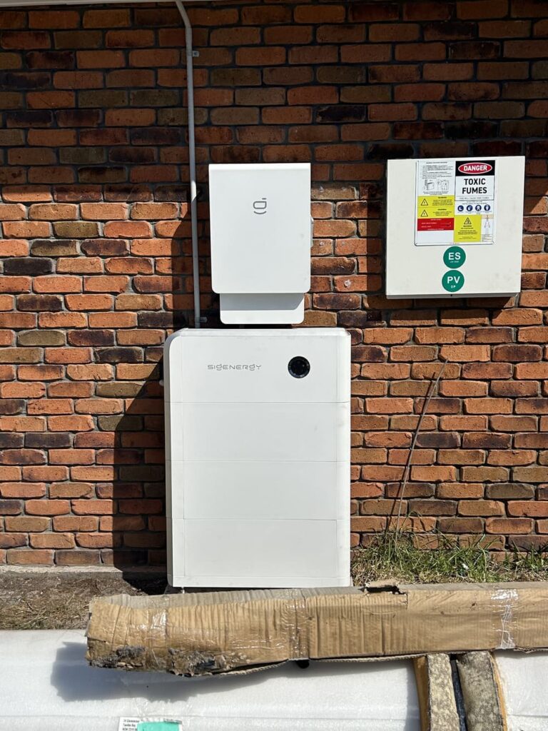 Home solar battery system mounted on brick wall