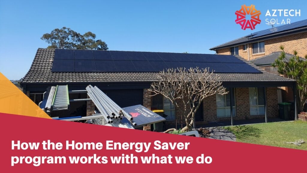 A residential house roof installed with a large array of solar panels, with installation equipment in the foreground.